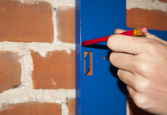 Marking out fixing holes using the ChargeLite mounting bracket