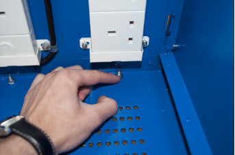 Screwing the holding nuts onto the studs on the floor of the ChargeLite