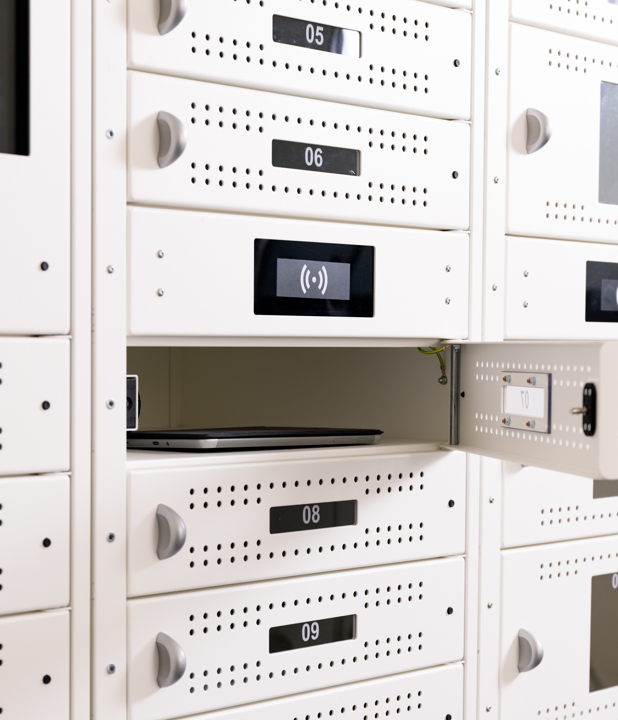 Old style Diplomat Pro locker bay doors with manual pull open locks. They have ventilation holes and pull handles.
