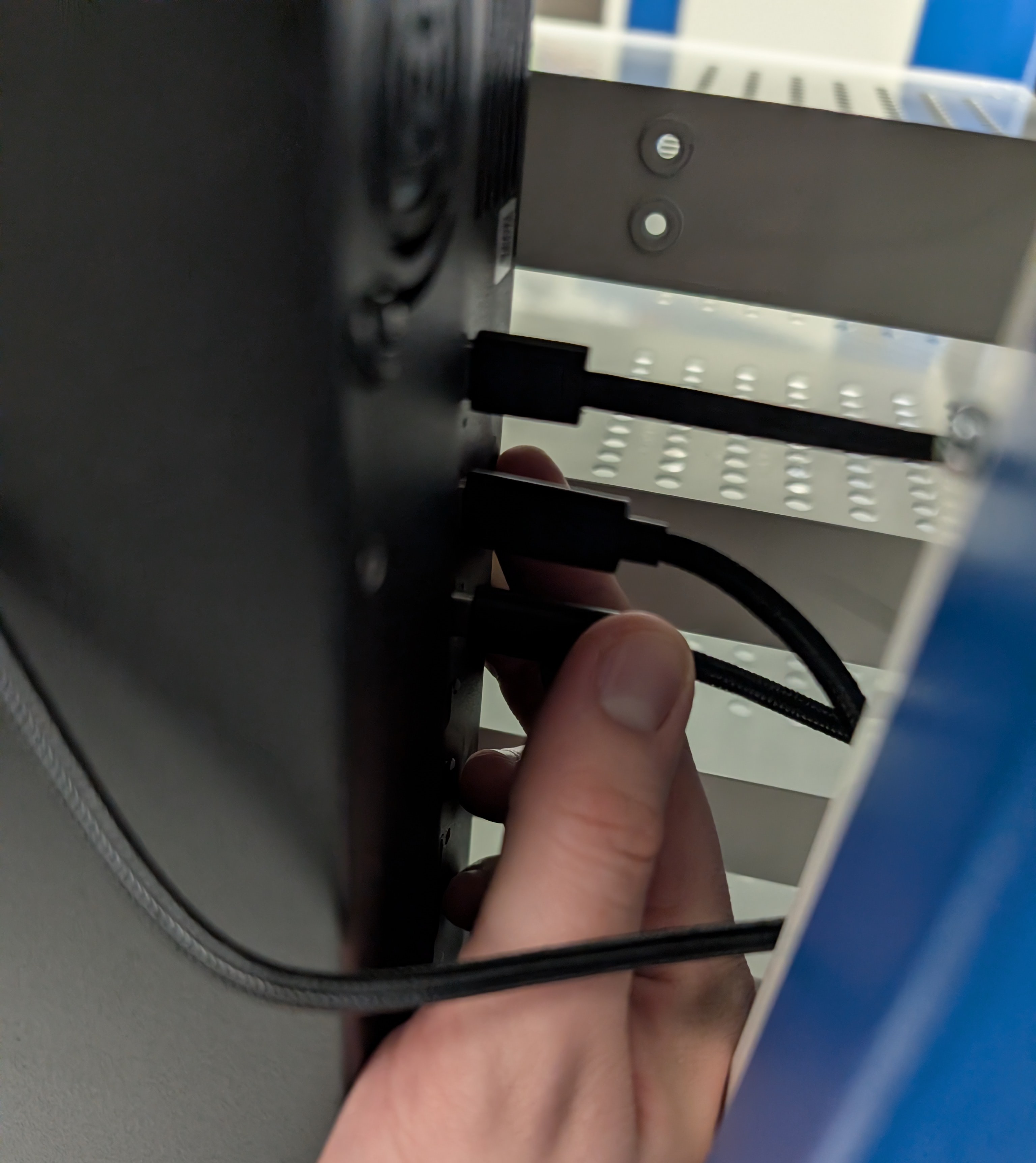 Plugging USB-C charging leads into the power banks at the rear of the ChargeLite trolley